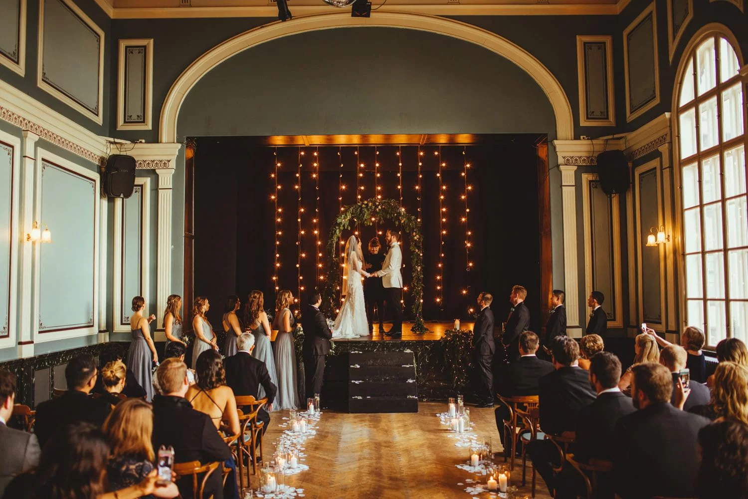 A couple being married in front of their loved ones at one of the most unique wedding venues in Europe, Idno Theatre, in Reykjavik, Iceland.