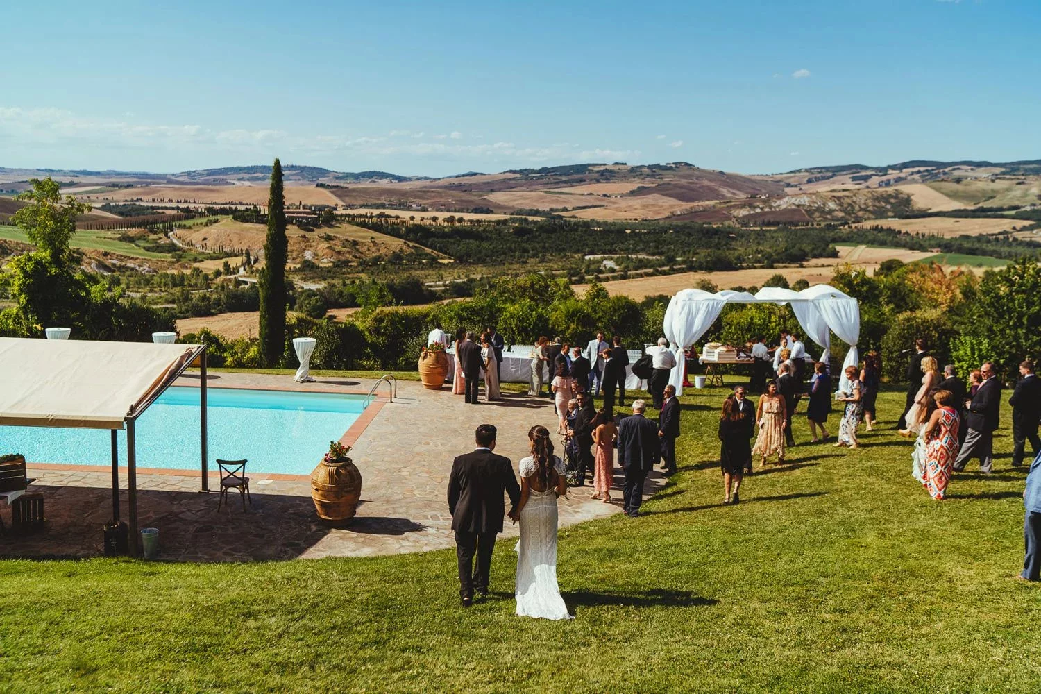 Wedding guests and a bride and groom gather in one of the best outdoor wedding venues in Europe, Borgo Di Castelvecchio.